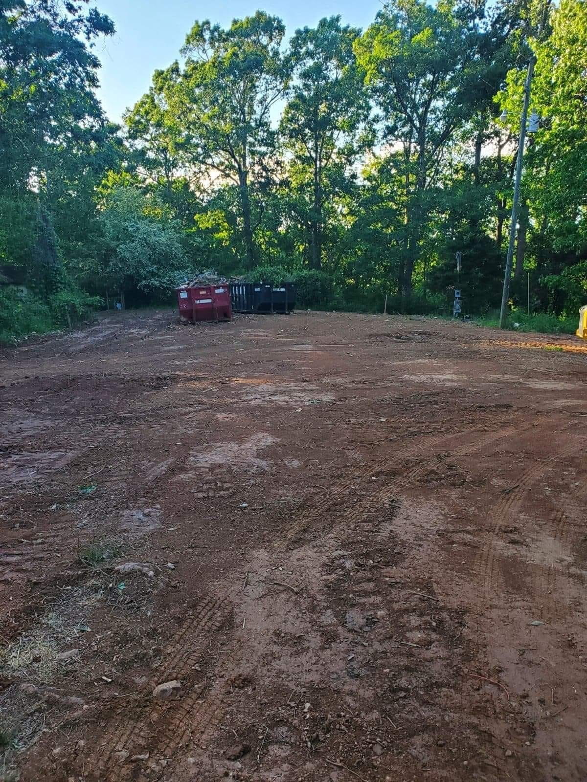 Completed cleared building site surrounded by trees