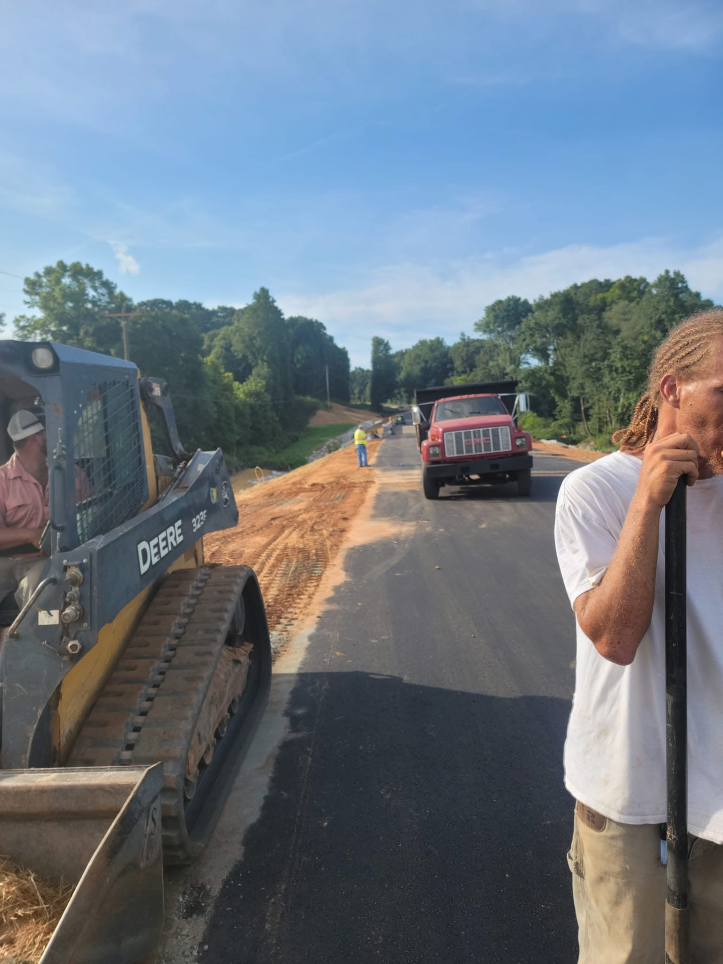J.M. Wilson crew and equipment working along a prepared roadway