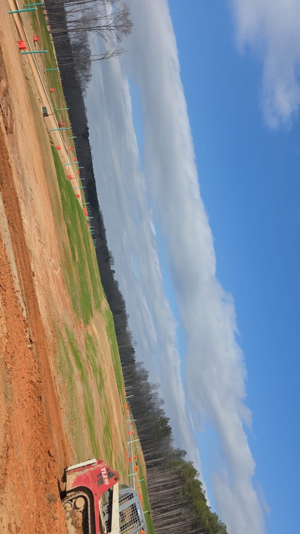 Large commercial site grading project with skid steer